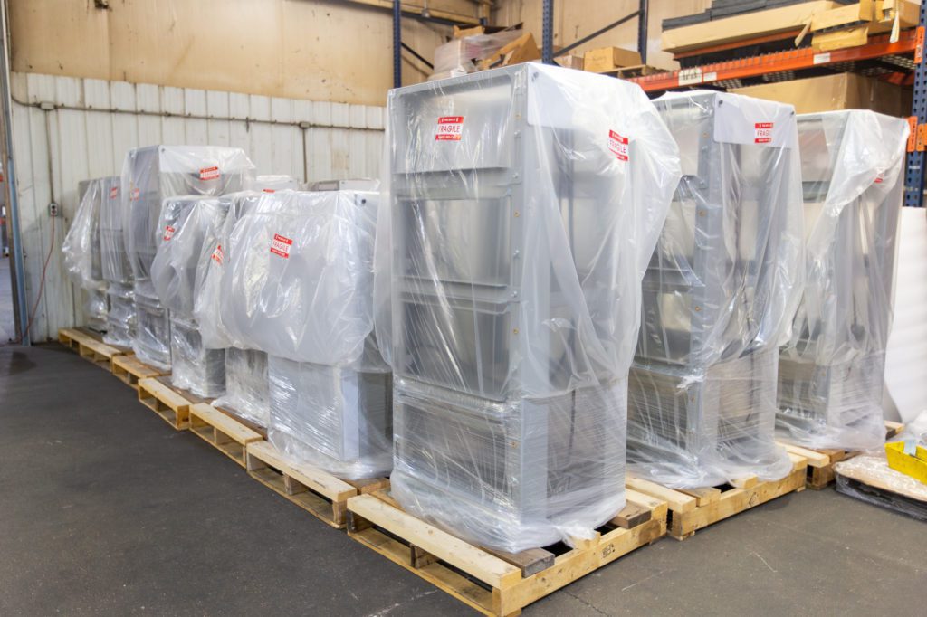 metal pieces stacked and wrapped in plastic wrap