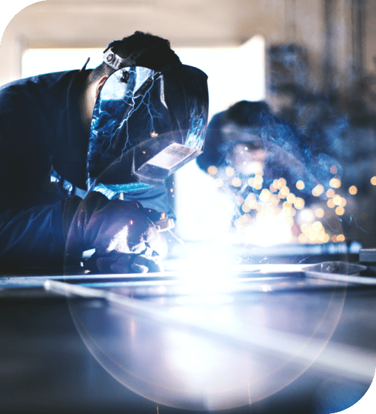 two welders work side by side